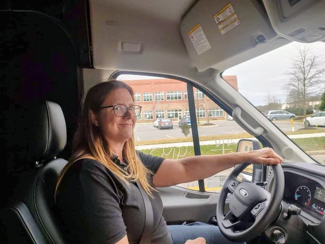 Mary Petrone smiling in her locksmith van, ready to help Virginia customers